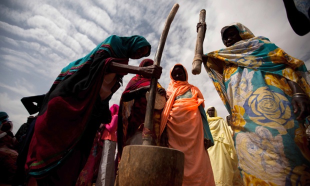 Sudanese women performing a demonstration of the cereal treating process during the visit of a delegation of ambassadors from European Union countries at the SAFE center in Sharga village, in North Darfur. The SAFE Centre is a project promoted by the World Food Program (WFP) and currently only run by the local community, where members make fuel efficient stoves to reduce the consumption of firewood.