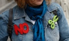 A demonstrator wears badges symbolizing no cuts during a protest by civil servants against government austerity measures in Madrid.