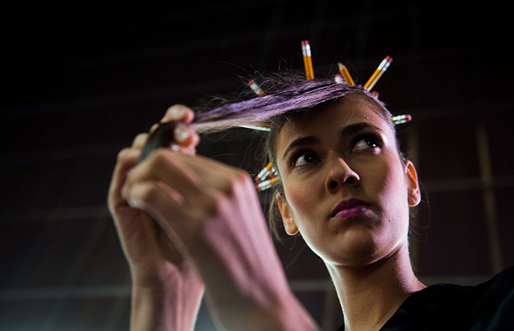 24 hours in pictures: A model gets ready at the backstage during Cali Exposhow