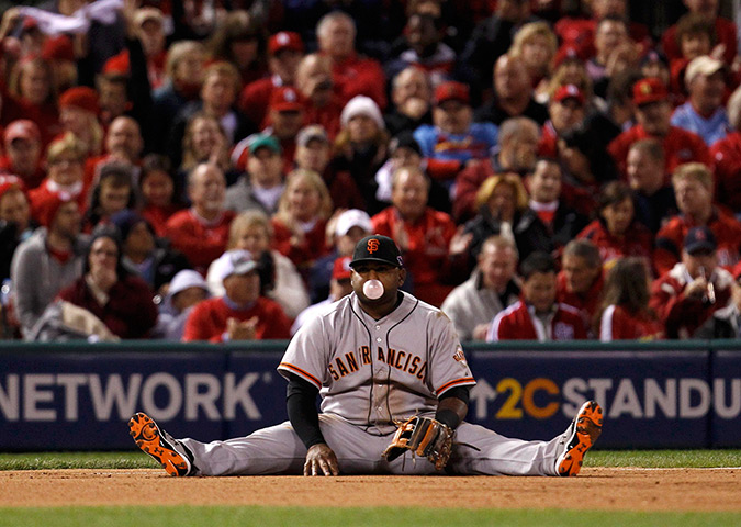 24 hours in pictures: San Francisco Giants third baseman Pablo Sandoval sits on the ground
