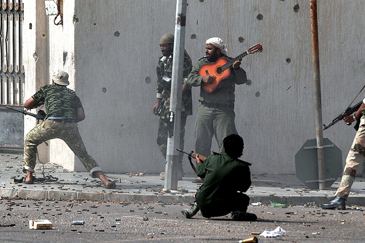 20 Photos: Libya's new regime forces fire their weapons at fighters loyal to Gaddafi