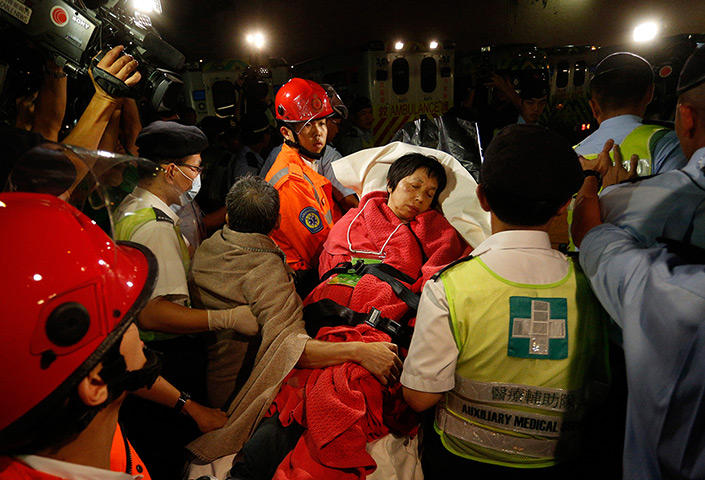 Hong Kong ferry: A survivor is carried by rescuers and taken onto shore 