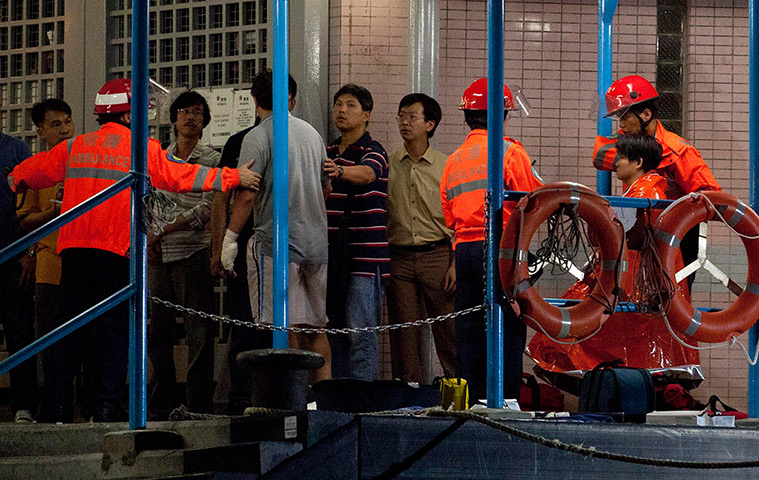 Hong Kong ferry: Two survivors, accompanied by rescuers, are taken onto shore 