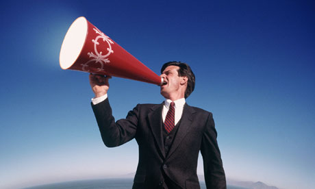 man shouts through megaphone