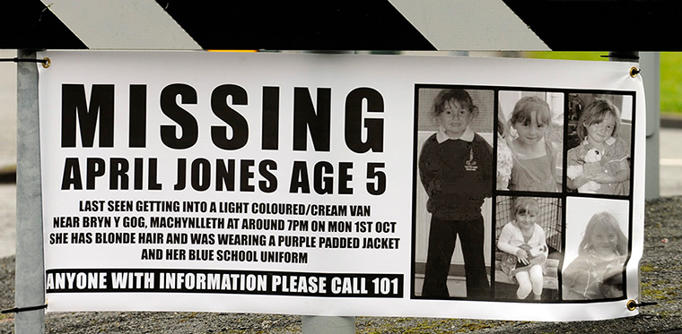 April Jones missing: A poster of April Jones at a roundabout