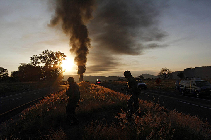 24 Hours: Mexican soldiers are seen backlighted after a gas pipeline explosion