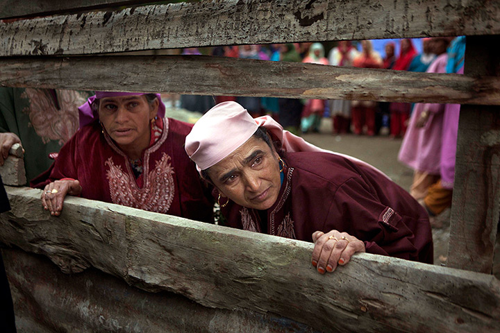 24 hours in pictures: Kashmiri villagers watch the funeral procession of civilian Farooq Ahmed