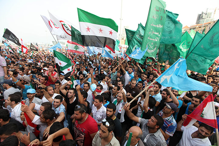 Beirut funeral: Protestes wave Syrian revolutionary flags, national flags and Islamic flags