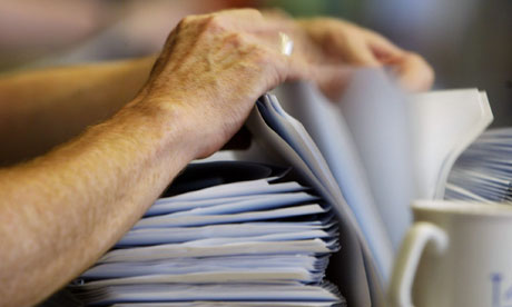 hands with papers and mug