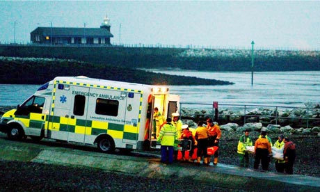 Rescue workers carry bodies into an ambulance at Morecambe in 2004