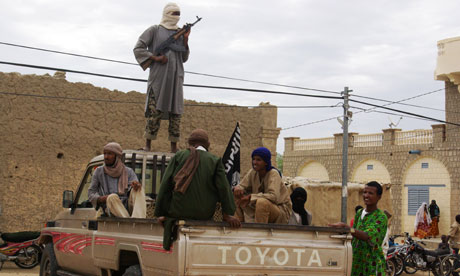 Ansar Dine fighters stand guard in Timbuktu, Mali