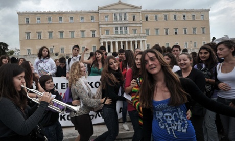 Youths, including public school art and music students, perform on October 23, 2012 outside the Greek Parliament  in the center of Athens during a demonstration against budget cuts affecting transport to schools.