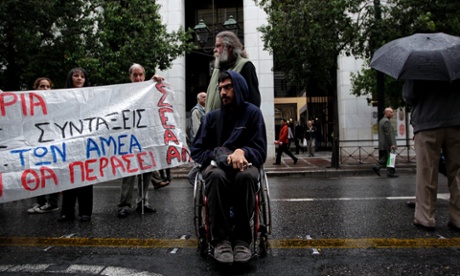 epa03443436 Disabled protesters demonstrate outside the Labour Ministry in Athens, Greece, 23 October 2012. People with a disability demonstrated throughout Greece on 23 October, protesting the discontinuation of their disability pensions and benefits until their re-evaluation by the Disability Certification Centers (KEPA). The demonstrators gathered outside the headquarters of the Social Security Foundation, while similar demonstrations were held in 36 other cities outside KEPA offices.