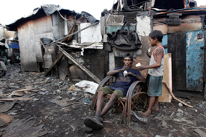 24 hours in pictures: Filipino charcoal workers eat meal at the makeshift  charcoal factory