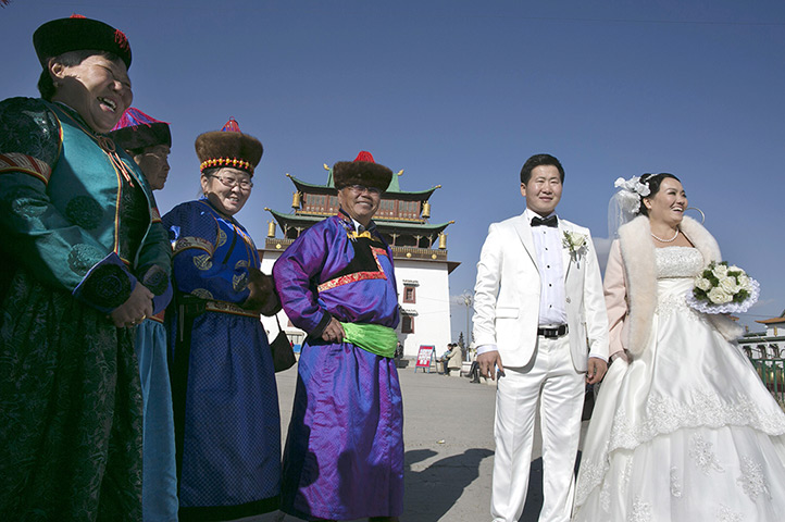 FTA: Paula Bronstein: A family poses in front of the Gandan monastery
