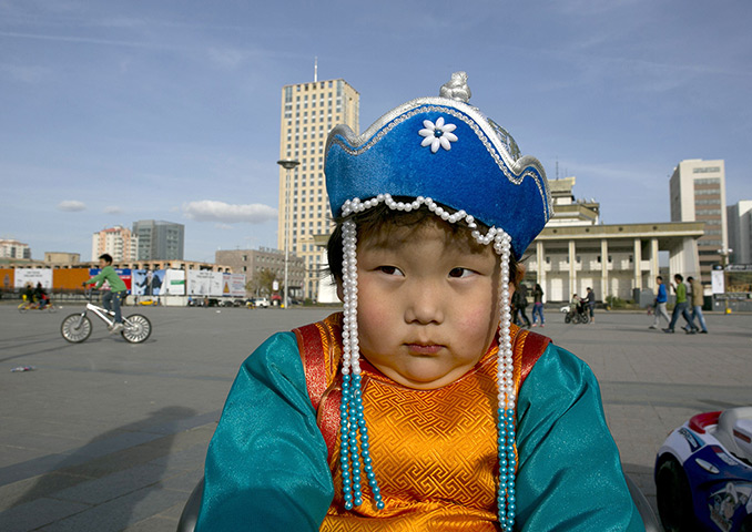 FTA: Paula Bronstein: A young boy sits in a motorised toy car in Sukhbataar Square, Ulan Bator