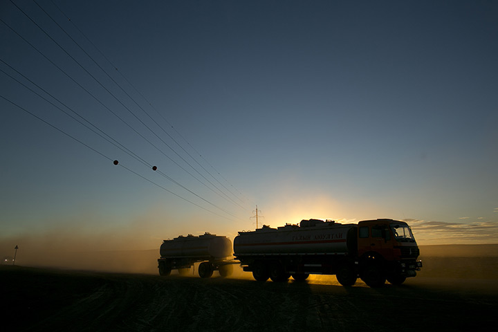 FTA: Paula Bronstein: A truck drives along  a new 110 km (68 miles) road in the south Gobi desert