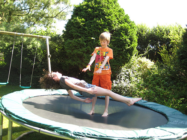 Your Pictures: trick: Two children trying levitation on a trampoline