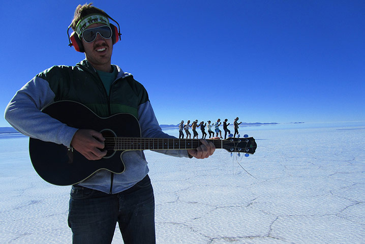 Your Pictures: trick: Perspective image of man in foreground with people walking along his guitar