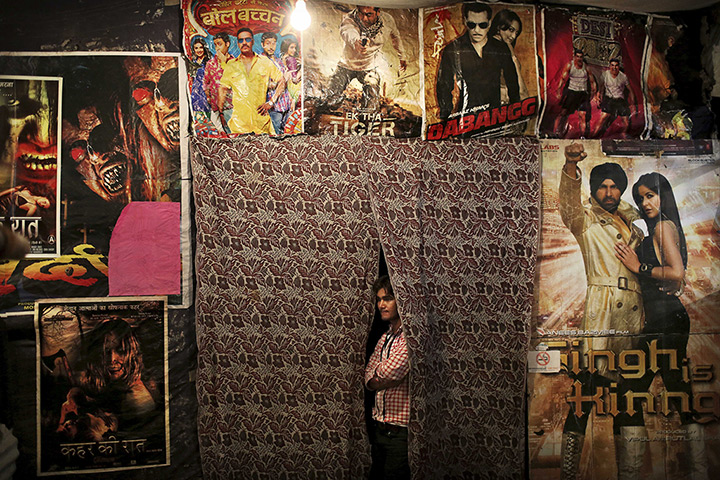 24 hours: New Delhi, India: A worker waits for customers at a small cinema
