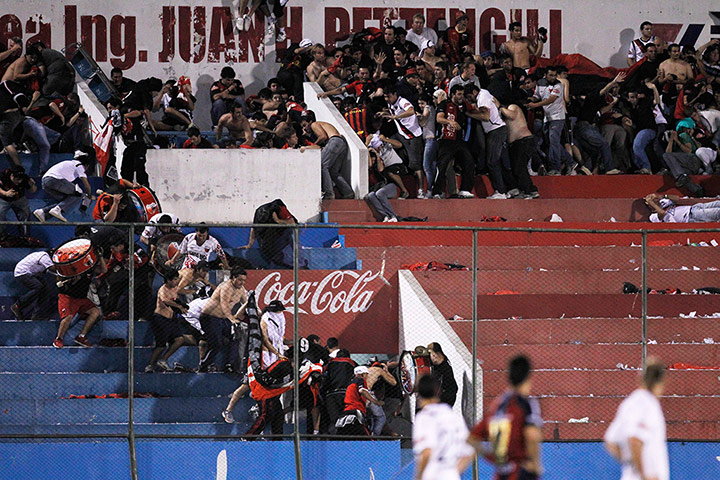 best of the week: Argentina's Colon's fans take cover as rubber bullets are fired by police