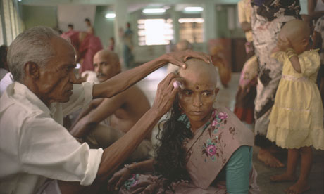 A woman donates her hair for auction at the Tirumala temple in India