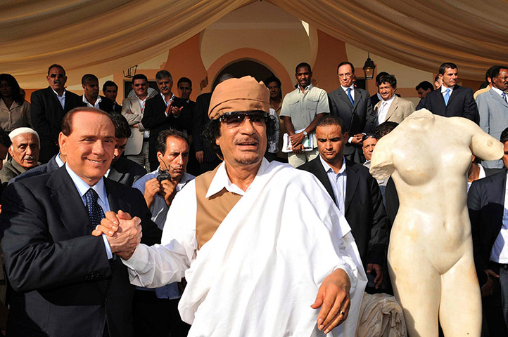 Berlusconi convicted: Berlusconi shakes hands with Libya's leader Gaddafi 
