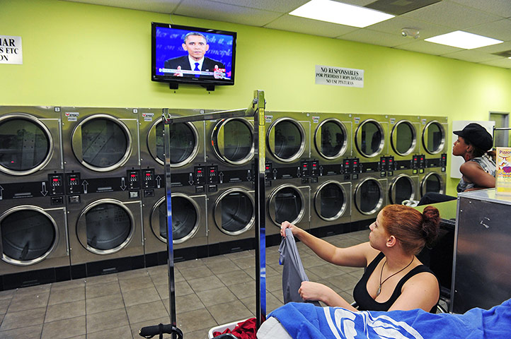 20 Photographs: Two women watch the presidential debate at a laundromat in Los Angeles