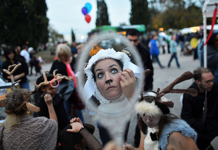24 hours: Baltimore, Maryland, USA: People get ready for a Halloween parade