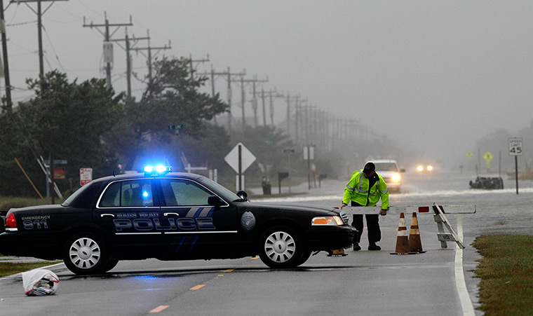 Hurricane Sandy : A police officer sets up a road block on South Oregon Inlet Road