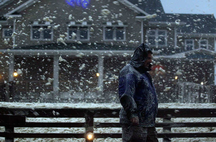Hurricane Sandy : High winds blow sea foam into the air across Jeanette's Pier 
