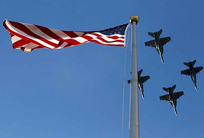 WS12: U.S. F/A-18 jets fly over an American flag at World Series 2012