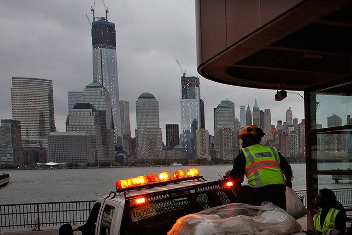 24 hours: New Jersey, USA: Workers place sandbags at Exchange Place