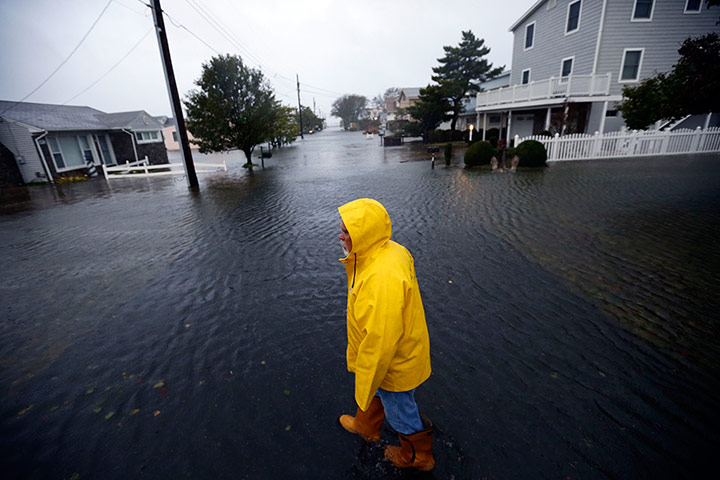 Hurricane Sandy : Al Daisey walks in the flood water in front of his home