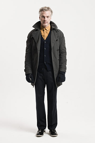 All Ages: Blue: Model wears trench coact with navy cardigan, navy trousers