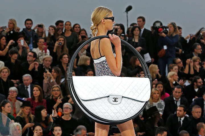 fashion accesories : A model with a Chanel handbag designed by Karl Lagerfeld 
