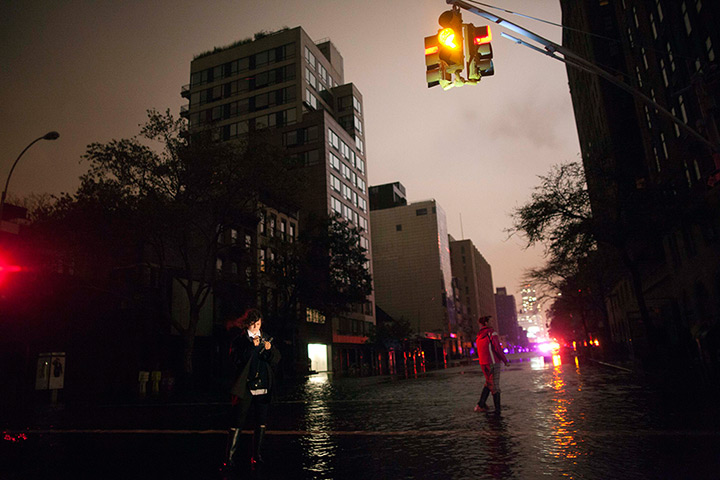 Sandy hits New York: People take photos on flooded street during blackout in Chelsea 