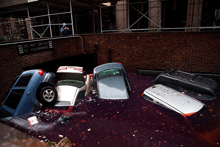 Sandy on east coast: Cars float in a flooded subterranean basement in the financial district 