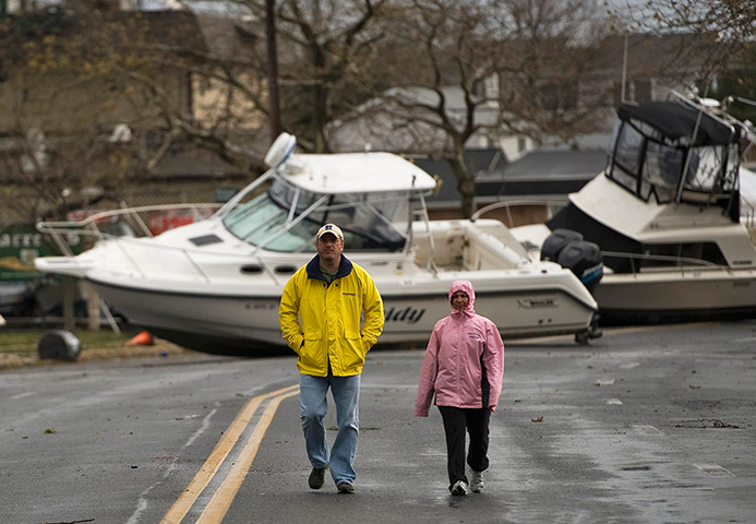 Sandy on east coast: Residents walk along Broadway Avenue in  Pleasant Beach, New Jersey
