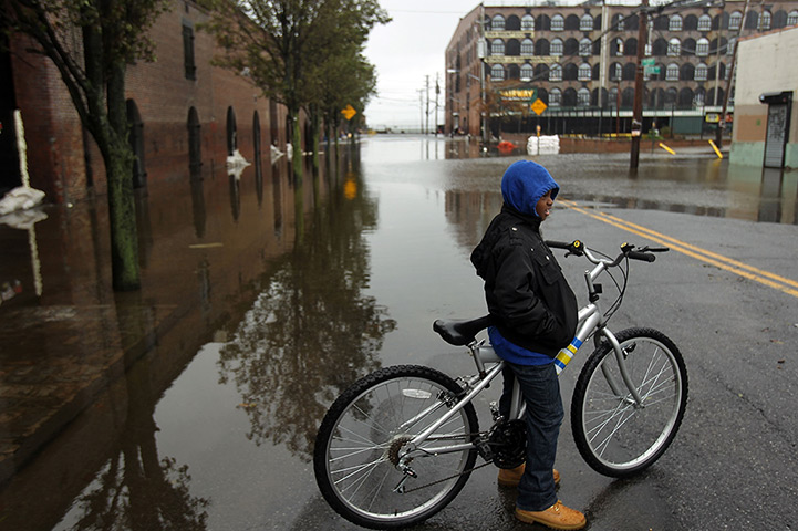 Sandy on east coast: A child stands in floods in the Red Hook section of Brooklyn