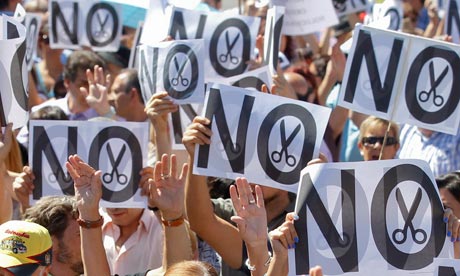 Civil servants hold up placards as they protest against government austerity measures in Madrid