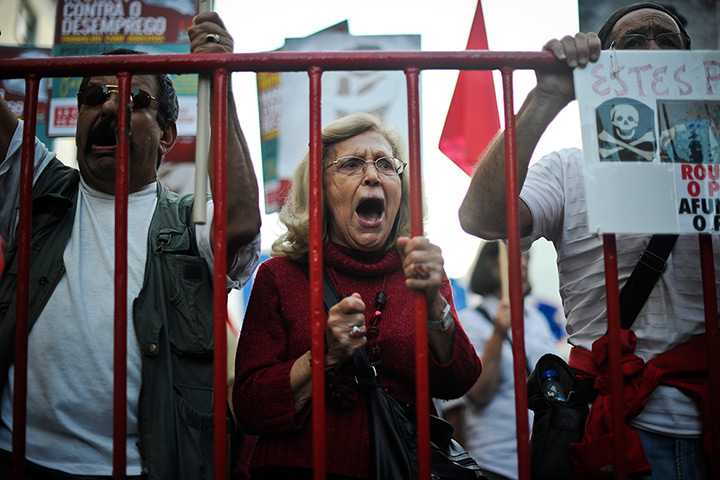 24 hours in pictures: Demonstrators shout slogans during a protest in Portugal