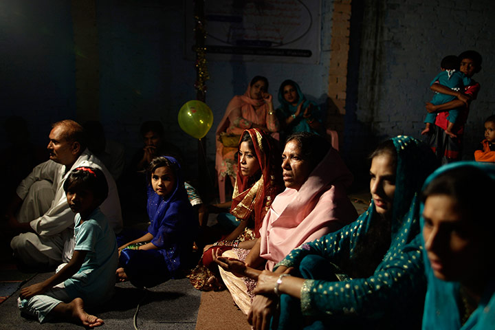 20 Photographs: Friends and relatives at a wedding in a church in Islamabad, Pakistan