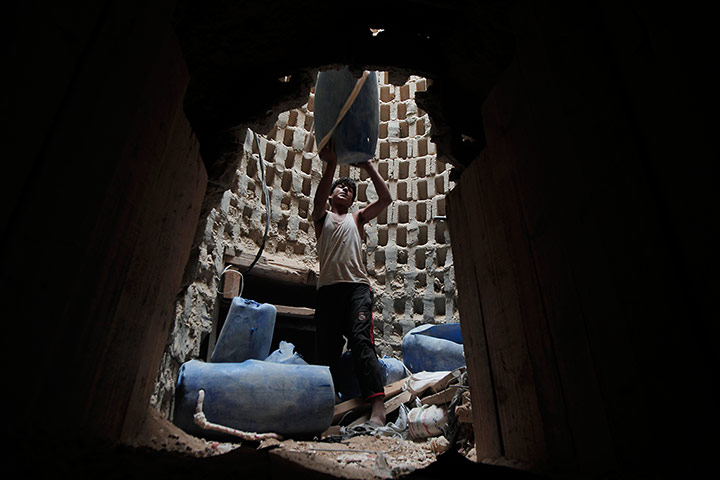 20 Photographs: A Palestinian smuggler in a tunnel along the Gaza-Egypt border