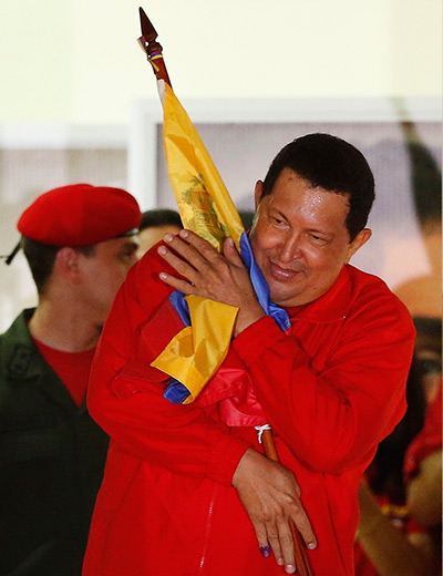 Venezuela elections: Venezuelan President Hugo Chavez hugs the national flag