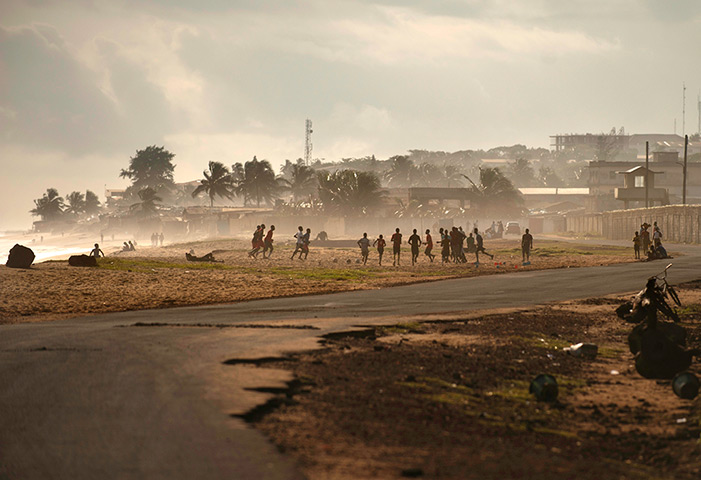 Liberia: Youngsters play football on the beach in Monrovia