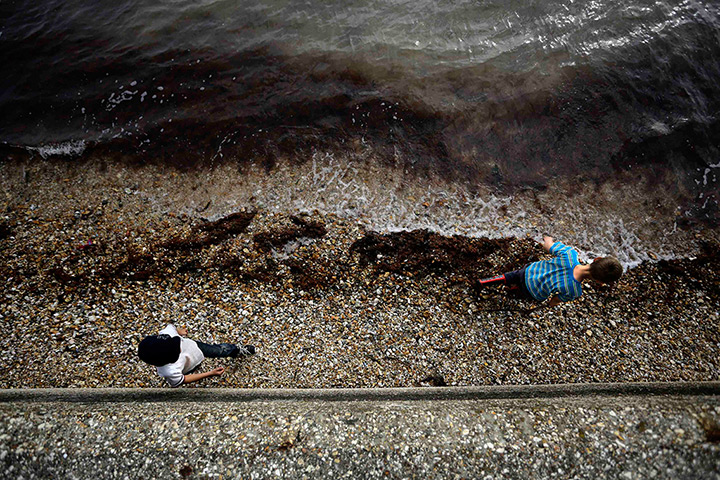 24 hours in pictures: Two boys walk along the beach on The Solent at Stokes Bay in Gosport