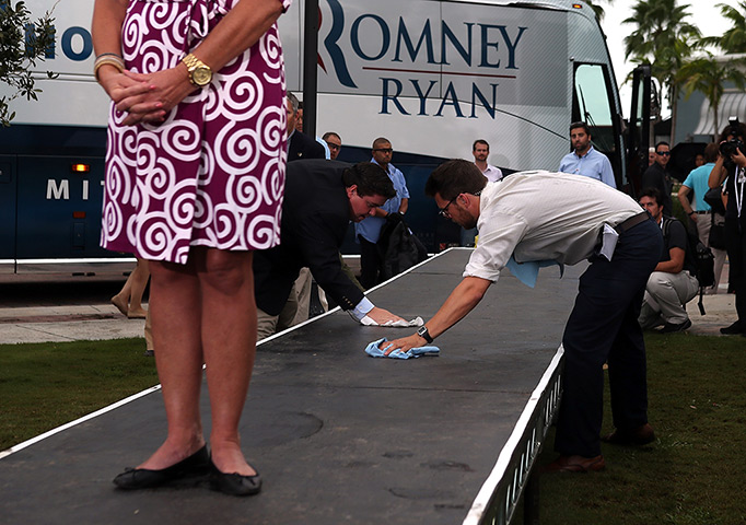 24 hours in pictures: Campaign staffers wipe down a runway as Ann Romney waits