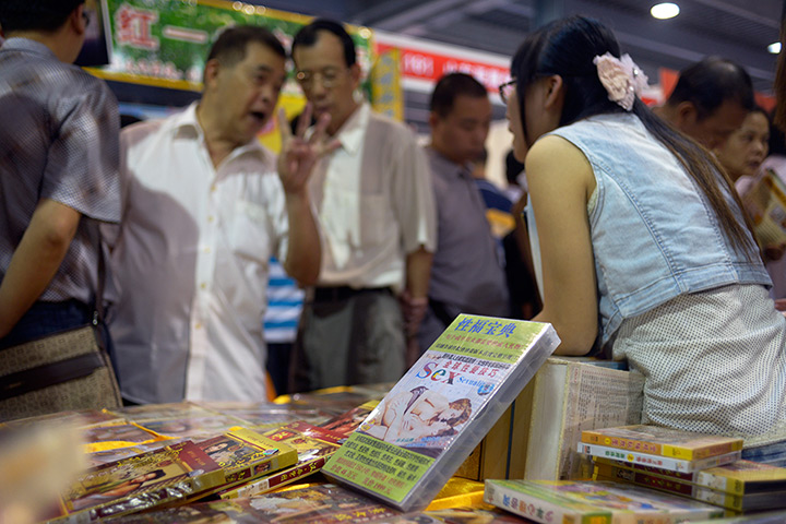 China Sex expo: A man haggles about the price of some 'instructional' sex DVDs on sale 