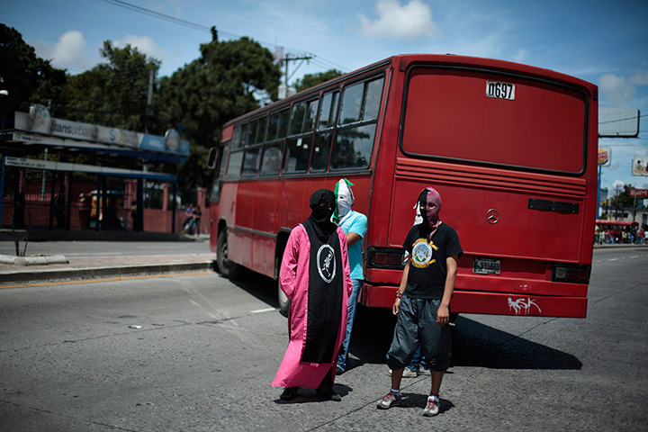 24 hours in pictures: Students stand next to a bus as they block the road